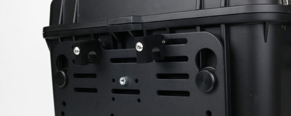 Close-up of a black storage box with a latch and mounting brackets