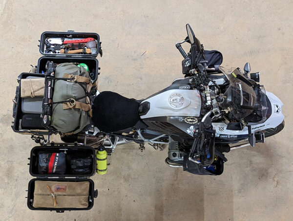 An overhead view of a packed motorcycle with gear and equipment