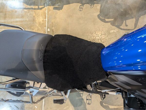 Top view of a motorcycle seat, featuring a black fuzzy seat cover