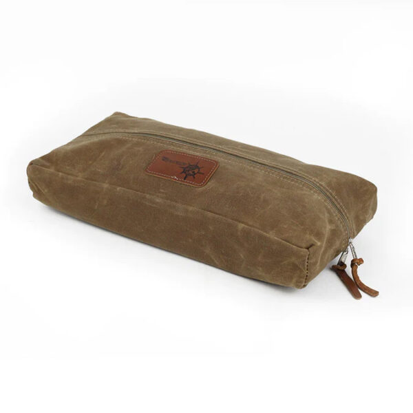 A brown waxed canvas pouch with a leather label and zipper